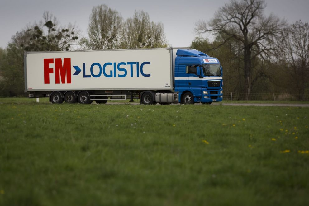 An FM Logistic truck driving on a road