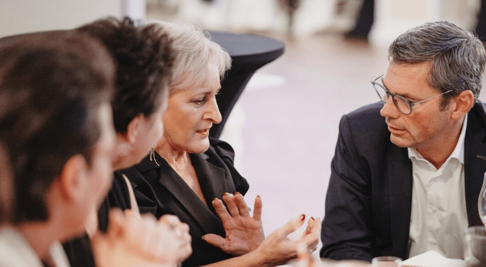 Our CEO, Orm, talking to three people at an event