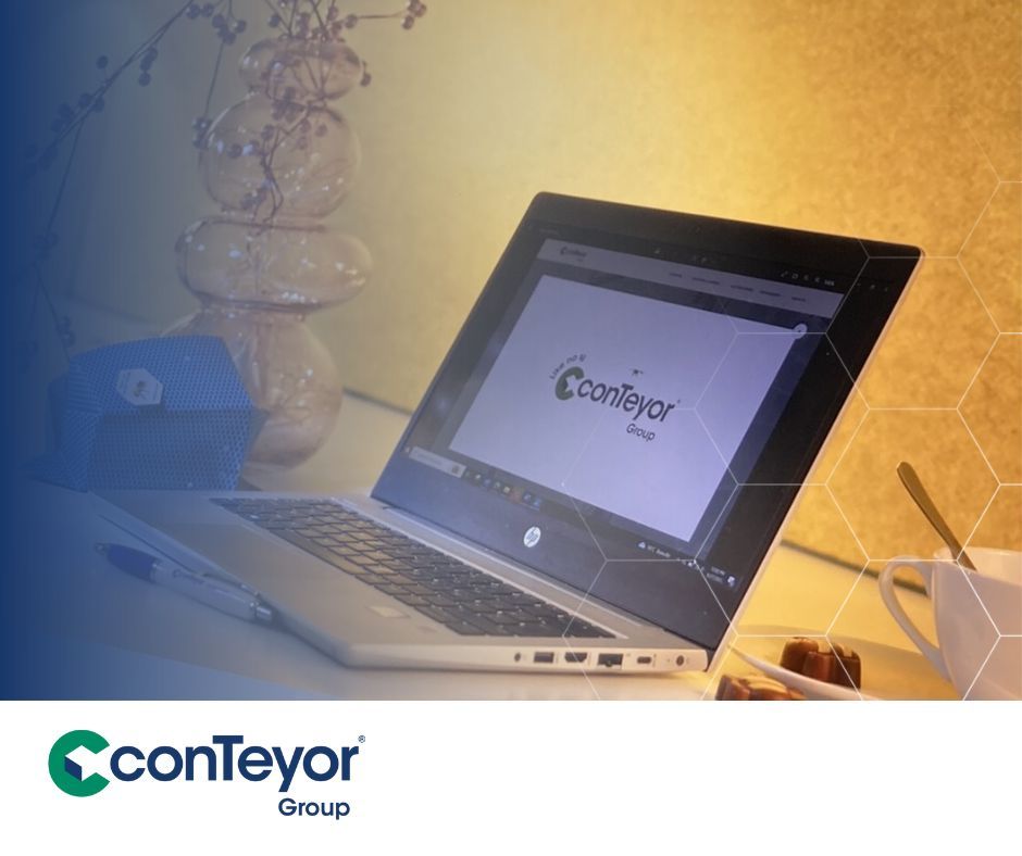A laptop with our new website displayed on a desk with a cosy light