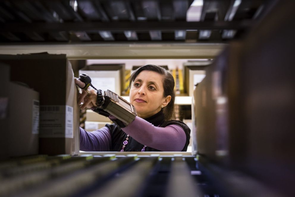 A woman picking orders in a warehouse.