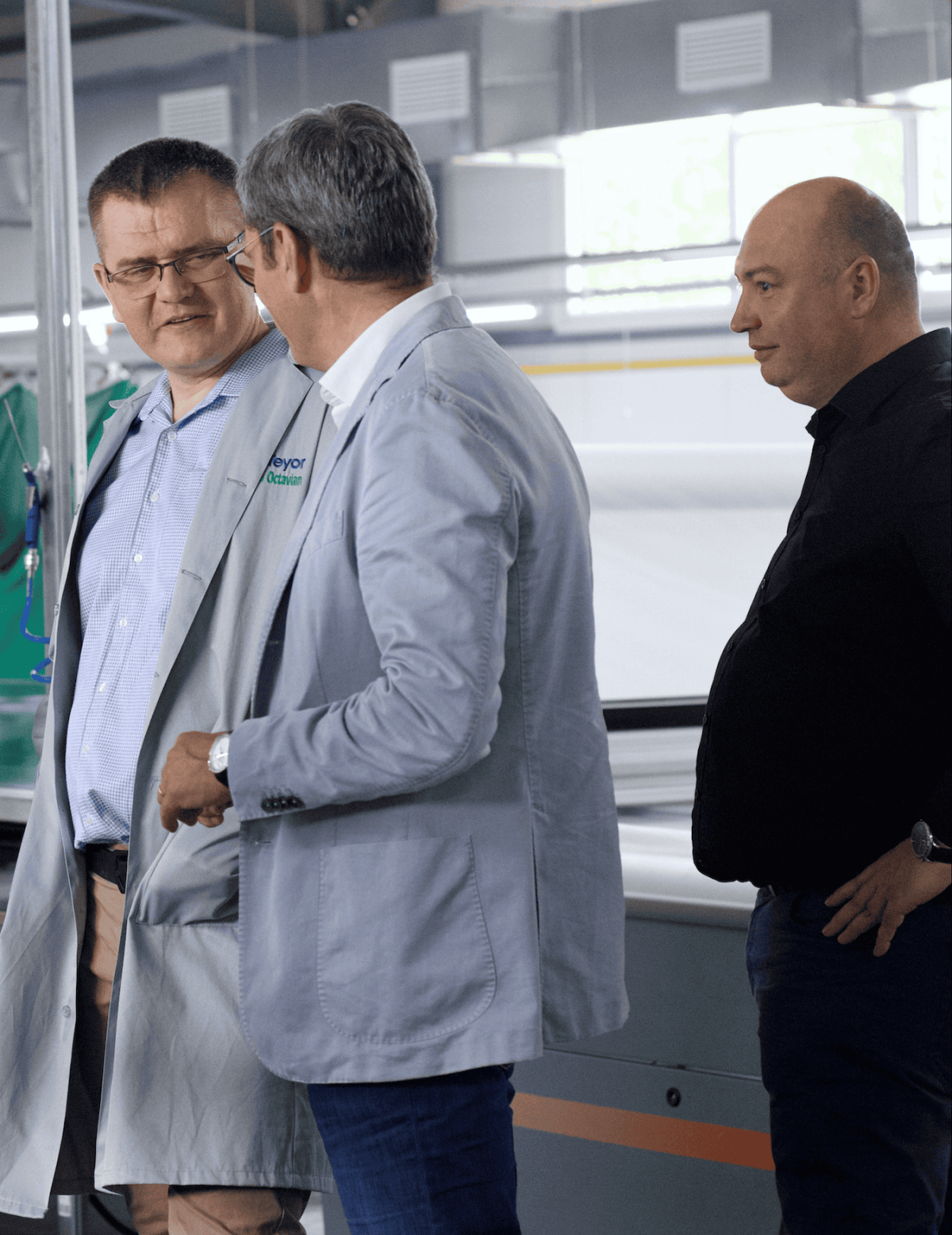 the conTeyor CEO, Orm, talking with two other men