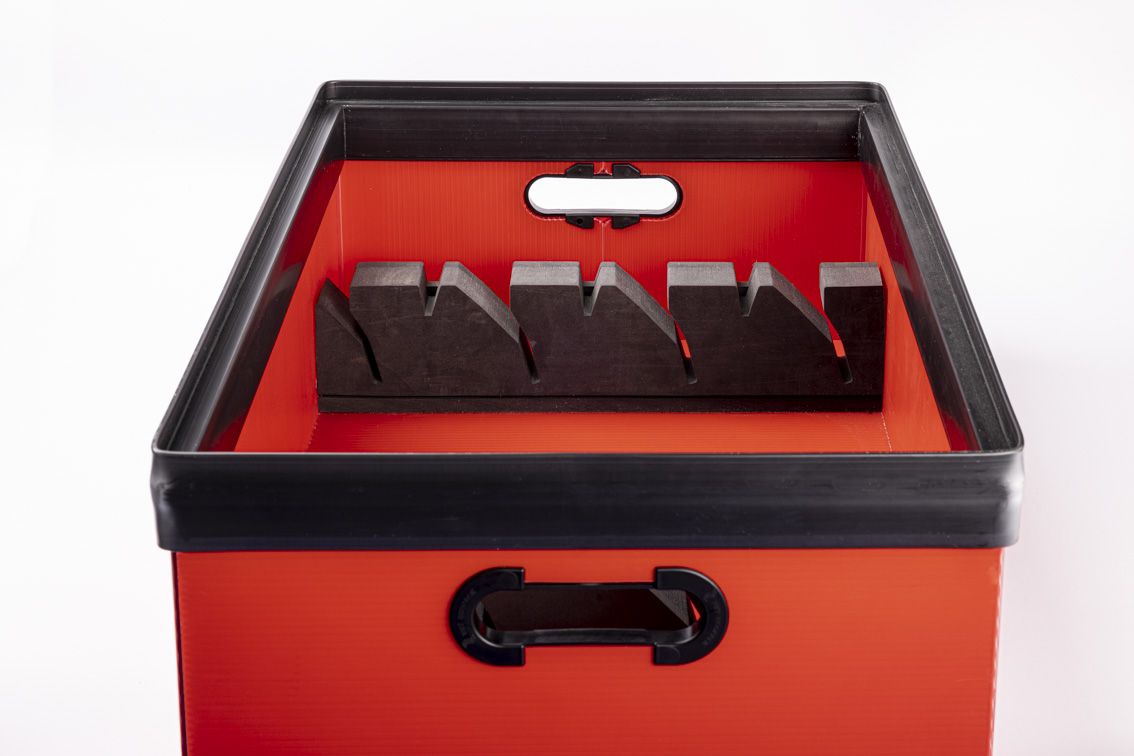 A detail shot of a red conTeyor Ecobox with black details