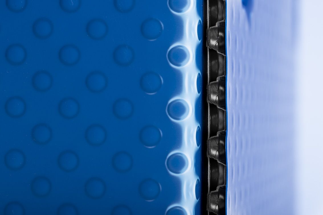 A detail shot of a blue conTeyor Ecobox with black details