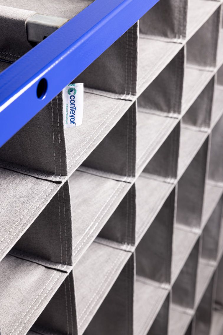 A close-up of a blue modular rack with textile inserts