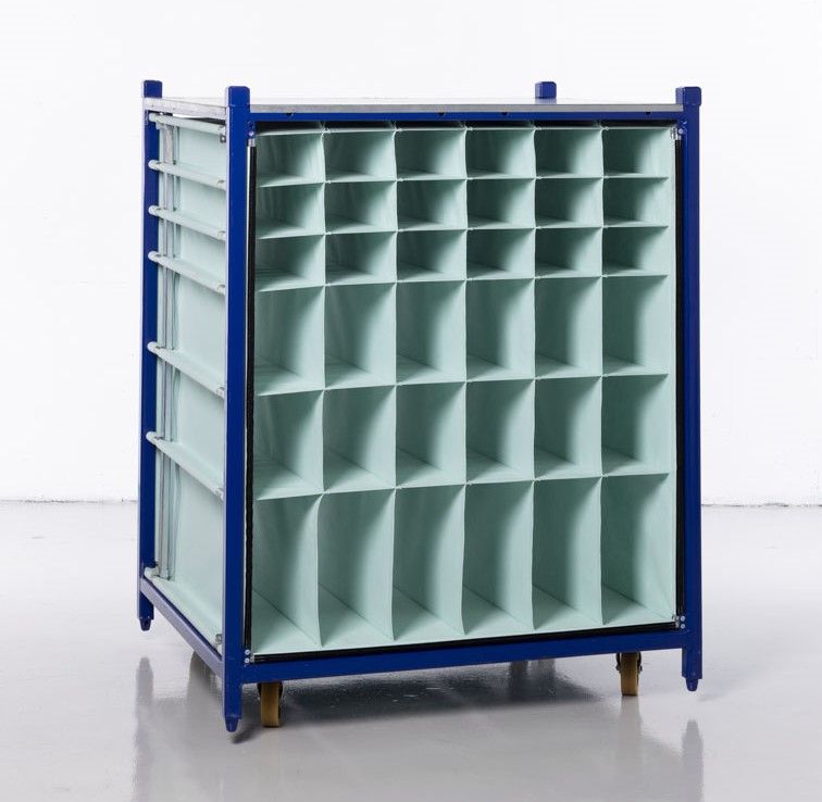 A close-up of a blue modular rack with textile inserts