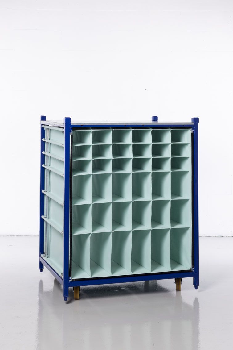 A close-up of a blue modular rack with textile inserts