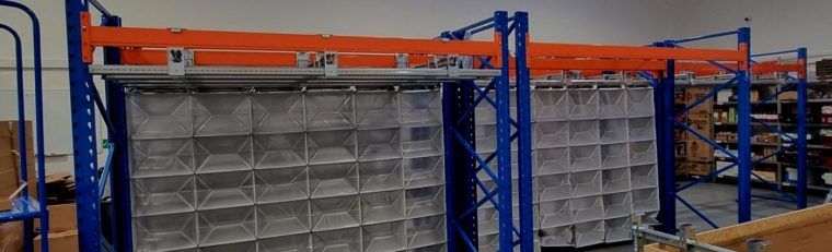 A Storeganizer system in orange and blue installed in a warehouse