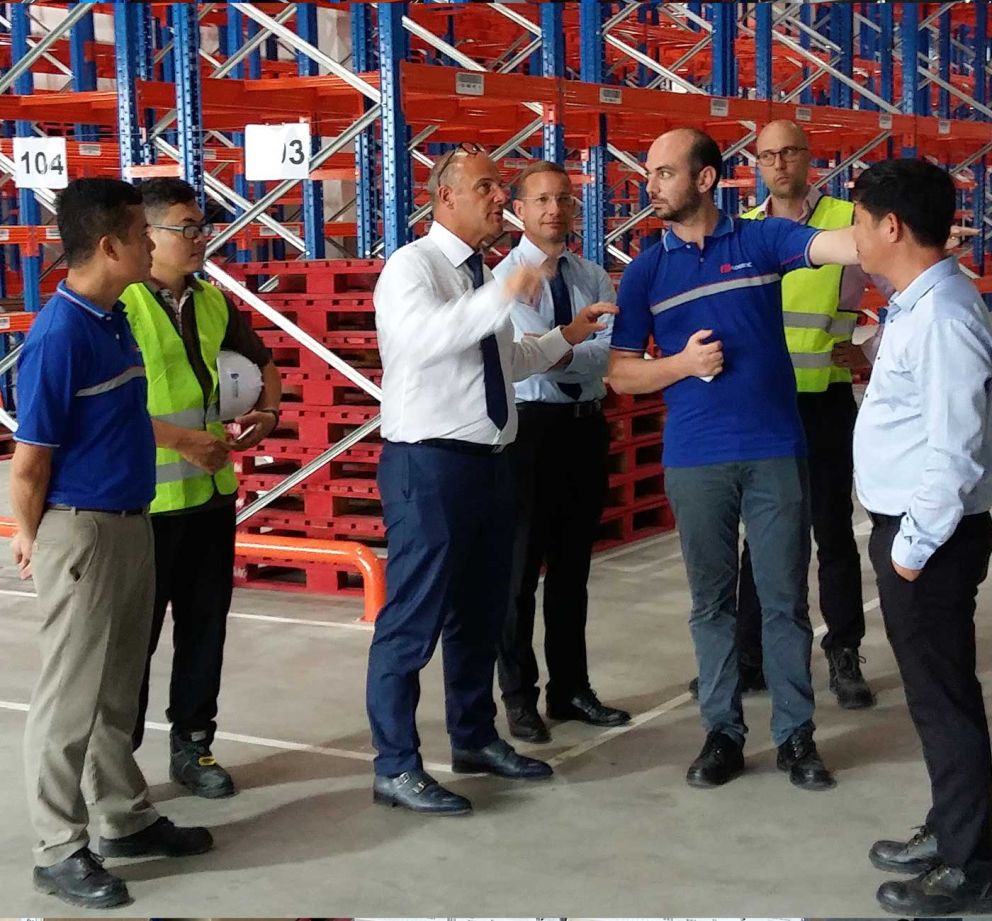 A couple of people discussing amongst eachother in a distribution centre in Vietnam