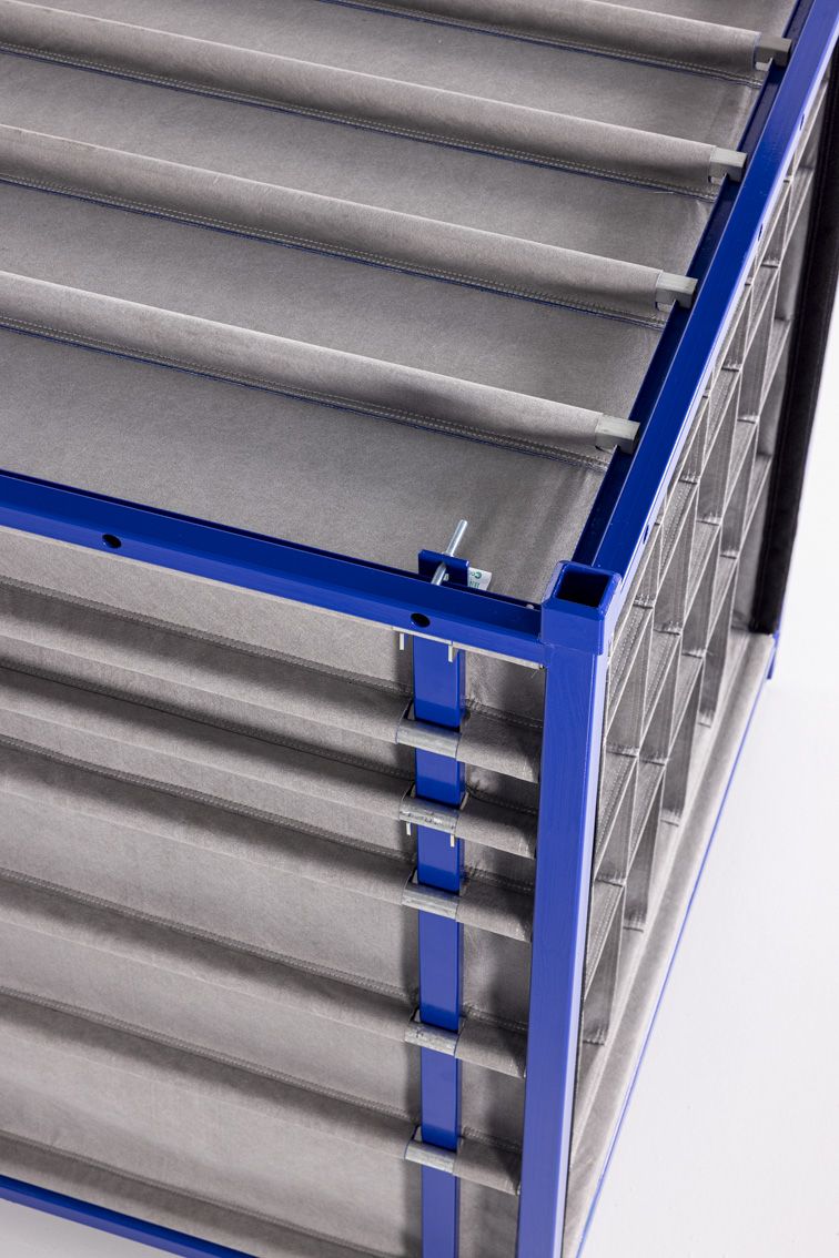 A close-up of a blue modular rack with textile inserts