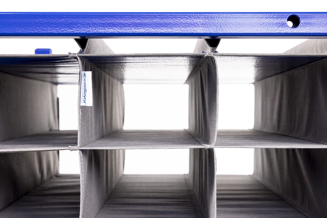 A close-up of a blue modular rack with textile inserts